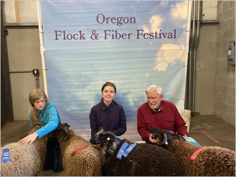 Award-winning sheep: the girls are cousins and their grandfather is on the right. Photo: Evelyn Taylor.